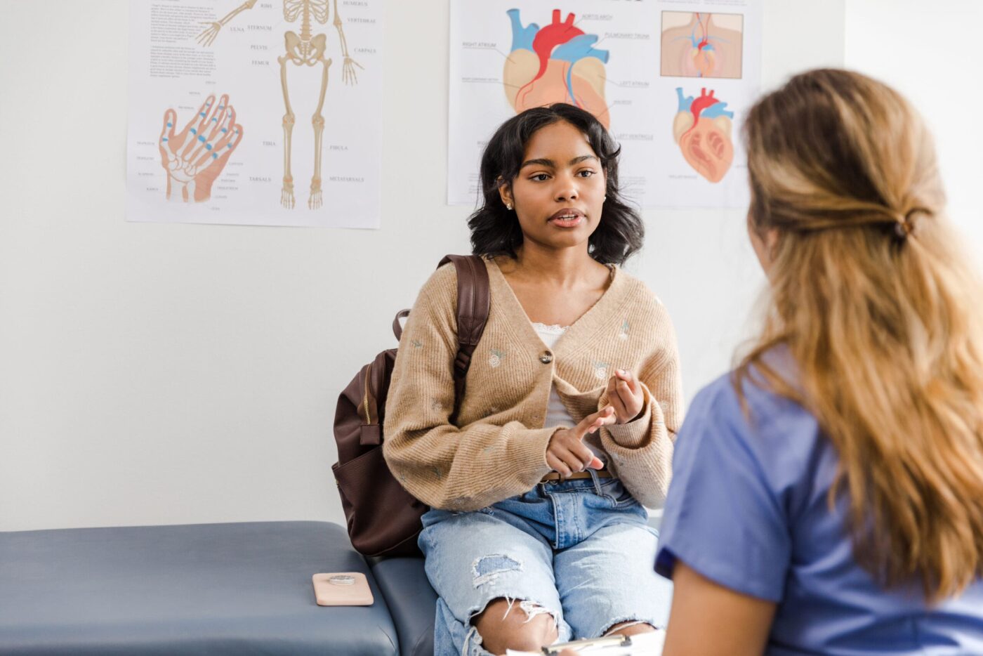Young adult female patient gestures while repeating instructions the healthcare worker just went over with her